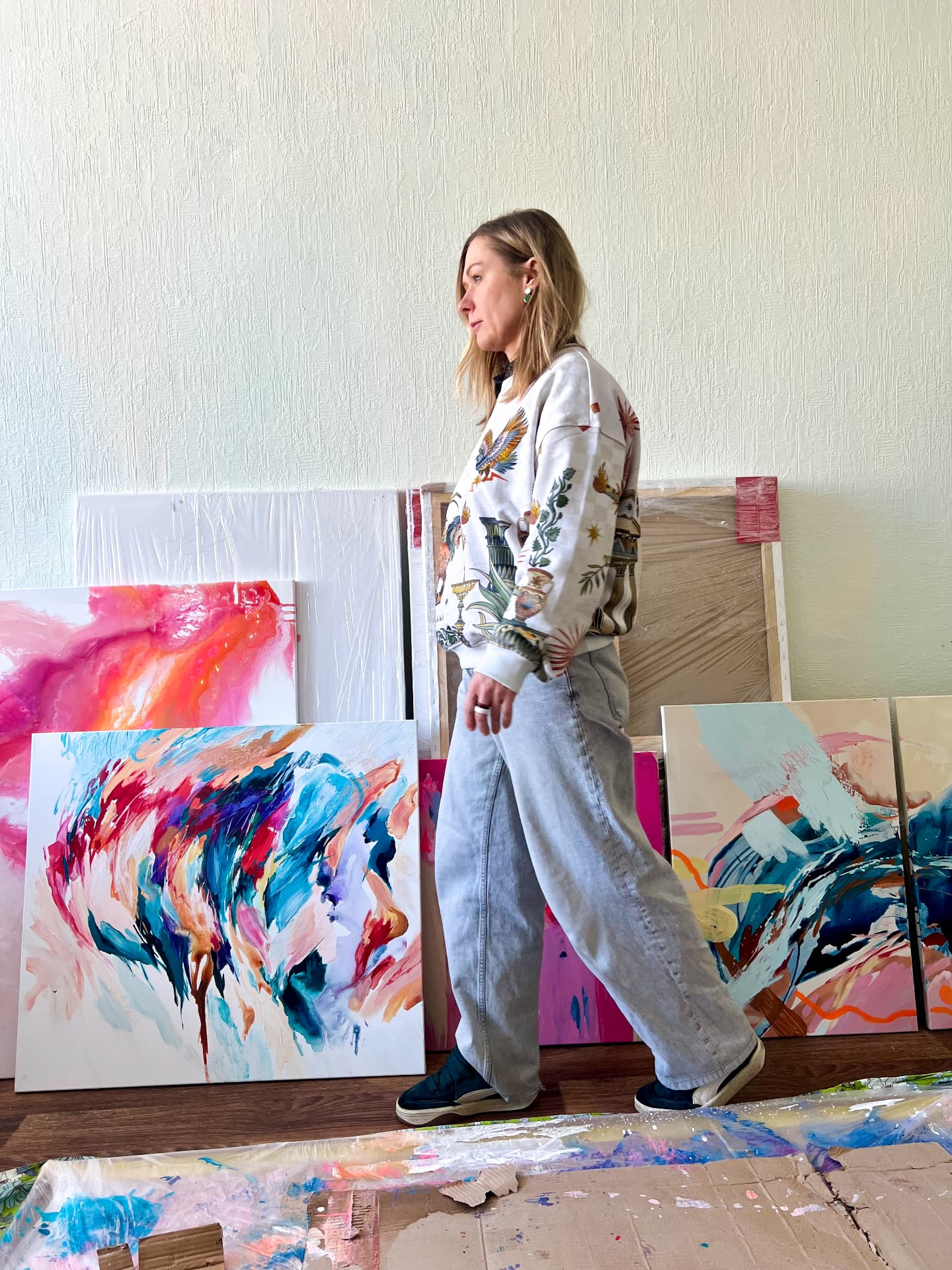 The artist in the studio among paintings